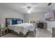 Comfortable main bedroom featuring a large bed, lots of pillows, ceiling fan and an adjacent office nook at 33 Palm Dr, Yalaha, FL 34797
