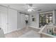 Cozy Bedroom with a crib, large window, and barn door leading to other living spaces at 33 Palm Dr, Yalaha, FL 34797