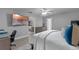 Spacious bedroom showcasing a bed with blue pillows, light grey walls, and a view of the office at 33 Palm Dr, Yalaha, FL 34797