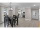 Inviting dining area with adjacent updated kitchen featuring sleek white cabinetry and modern appliances at 33 Palm Dr, Yalaha, FL 34797