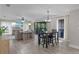Open-concept dining and living area with modern lighting, wood-look floors, and comfortable seating at 33 Palm Dr, Yalaha, FL 34797