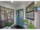 Inviting entryway featuring a teal front door, sidelight windows, and stylish interior accents at 33 Palm Dr, Yalaha, FL 34797