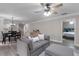 Open concept living area with modern furniture, wood-look floors, and ample natural light at 33 Palm Dr, Yalaha, FL 34797