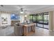 Bright living room featuring neutral tones, modern furniture, and sliding glass doors to the outdoor deck at 33 Palm Dr, Yalaha, FL 34797