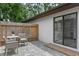 Outdoor patio area with comfortable seating and a sliding glass door leading to the modern bathroom at 33 Palm Dr, Yalaha, FL 34797
