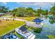 Beautiful waterfront property with private boat docks and lush landscaping at 33 Palm Dr, Yalaha, FL 34797