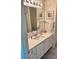Well-lit bathroom featuring a vanity with a sink, bright mirror, and neutral wall decor at 3337 Candlebrook St, The Villages, FL 32162