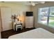 Bright bedroom with a window, hardwood floors, a dresser, and a vanity at 3337 Candlebrook St, The Villages, FL 32162
