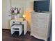 Bedroom featuring a dresser, vanity, window, and hardwood floors at 3337 Candlebrook St, The Villages, FL 32162