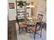 Dining room featuring a glass table, chandelier and view into the kitchen at 3337 Candlebrook St, The Villages, FL 32162
