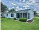 Charming exterior of a single-story home with a lush green lawn and cozy sunroom at 3337 Candlebrook St, The Villages, FL 32162