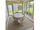 Bright Florida room with a ceiling fan, many windows and a table with four chairs at 3337 Candlebrook St, The Villages, FL 32162