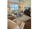 Inviting living room with plush sofas, a ceiling fan, and a stylish rug over hardwood floors at 3337 Candlebrook St, The Villages, FL 32162