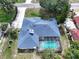 Aerial view of home with a screened-in pool, lush landscaping, and a spacious backyard at 33913 Sabal Way, Leesburg, FL 34748