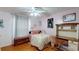 Bedroom features a ceiling fan, hardwood floors, and a desk/vanity area at 33913 Sabal Way, Leesburg, FL 34748