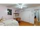 Bedroom features a ceiling fan, hardwood floors, and a closet with sliding doors at 33913 Sabal Way, Leesburg, FL 34748
