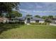 Charming single-story home with lush front yard and mature trees offering curb appeal at 33913 Sabal Way, Leesburg, FL 34748
