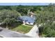 Charming single-story home with a well-manicured lawn, mature trees, and a welcoming driveway at 33913 Sabal Way, Leesburg, FL 34748