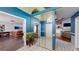 Bright foyer with mirrored closet doors, tile flooring, and views into the living room and dining area at 33913 Sabal Way, Leesburg, FL 34748