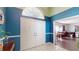 Inviting foyer boasts white tile flooring, a striking blue accent wall, and an open view into the dining area at 33913 Sabal Way, Leesburg, FL 34748