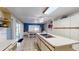 Spacious kitchen with an island cooktop, white cabinetry, and an adjoining dining area with sliding glass doors at 33913 Sabal Way, Leesburg, FL 34748