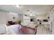 Open kitchen features an island, stainless steel appliances, and adjacent dining area at 33913 Sabal Way, Leesburg, FL 34748