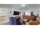 Bright living room with hardwood floors features a TV and comfortable seating arrangement at 33913 Sabal Way, Leesburg, FL 34748