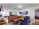 Living room with hardwood floors features a floral sofa and contemporary furnishings at 33913 Sabal Way, Leesburg, FL 34748