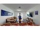 Open living room with hardwood floors features TV, comfortable seating, and access to the backyard at 33913 Sabal Way, Leesburg, FL 34748