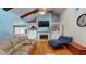 Bright living room with vaulted ceiling, fireplace, and blue accent wall paint at 33913 Sabal Way, Leesburg, FL 34748