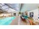 This covered patio features a private pool surrounded by lounge seating and a dining area at 33913 Sabal Way, Leesburg, FL 34748