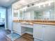 Bright bathroom featuring double vanity with granite counters and decorative turtle accents above the mirror at 3425 S Atlantic Ave # 1101, Daytona Beach, FL 32118
