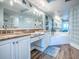 Bright bathroom featuring double vanities, granite countertops, and a separate tub at 3425 S Atlantic Ave # 1101, Daytona Beach, FL 32118