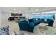Open-concept common room with a kitchen bar, lounge area, large sectional sofa, and picturesque ocean views at 3425 S Atlantic Ave # 1101, Daytona Beach, FL 32118