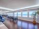 Bright oceanfront dining room with dark wood floors and large windows showcasing the view at 3425 S Atlantic Ave # 1101, Daytona Beach, FL 32118