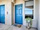 Condo entrance with a blue door, a window, and a decorative plant at 3425 S Atlantic Ave # 1101, Daytona Beach, FL 32118