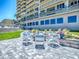 Inviting outdoor fire pit with seating and landscaping near the condo building at 3425 S Atlantic Ave # 1101, Daytona Beach, FL 32118