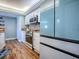 Updated kitchen boasts wood flooring, stainless steel oven, and light blue accents at 3425 S Atlantic Ave # 1101, Daytona Beach, FL 32118