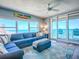 Inviting living room featuring ocean views, a plush blue sectional, and access to a private balcony at 3425 S Atlantic Ave # 1101, Daytona Beach, FL 32118