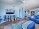 Comfortable living area with flat screen tv, area rug and blue accents at 3425 S Atlantic Ave # 1101, Daytona Beach, FL 32118