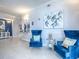 Inviting lobby area with two blue velvet chairs, artwork, and tile flooring, with an attractive welcome desk at 3425 S Atlantic Ave # 1101, Daytona Beach, FL 32118