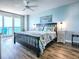 Bright main bedroom with private balcony, wood-look flooring, and charming coastal decor at 3425 S Atlantic Ave # 1101, Daytona Beach, FL 32118