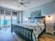 Bright bedroom featuring light walls, wood-look floors, and balcony access with a gorgeous ocean view at 3425 S Atlantic Ave # 1101, Daytona Beach, FL 32118