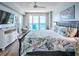 Bright bedroom featuring light walls, wood-look floors, and balcony access with a view of the sea at 3425 S Atlantic Ave # 1101, Daytona Beach, FL 32118