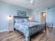 Serene bedroom featuring a dark wood bed frame, bright floral bedding and coastal decor at 3425 S Atlantic Ave # 1101, Daytona Beach, FL 32118