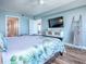Inviting bedroom featuring a view of the bath, TV, and serene decor at 3425 S Atlantic Ave # 1101, Daytona Beach, FL 32118