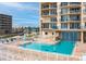 Sparkling community pool and spa with lounge chairs, tables, and blue accents at 3425 S Atlantic Ave # 1101, Daytona Beach, FL 32118
