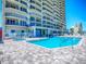 Inviting community pool and spa with building views at 3425 S Atlantic Ave # 1101, Daytona Beach, FL 32118