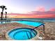 Pool and hot tub overlooking the ocean with lounge chairs at 3425 S Atlantic Ave # 1101, Daytona Beach, FL 32118