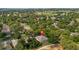 Aerial view of the property showcasing the screened-in pool, mature trees, and surrounding neighborhood near the golf course at 3607 Fairfield Dr, Clermont, FL 34711